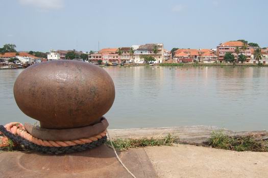 A view from a quay towards the city centre at the port in Bissau. Many of the ships in the harbor would most likely never leave port. Not all the ships were completely destroyed because out of the picture's view a modern container terminal could be seen.